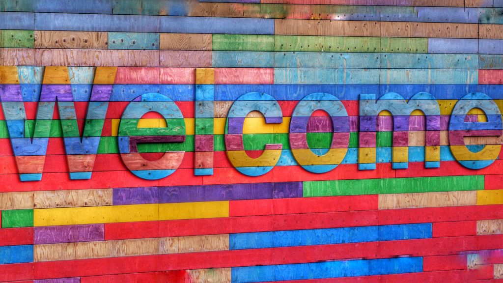 Colourful "Welcome" sign painted on a wall
