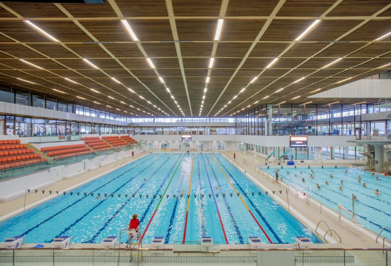 Indoor swimming pool and spectator seating at a modern council leisure centre