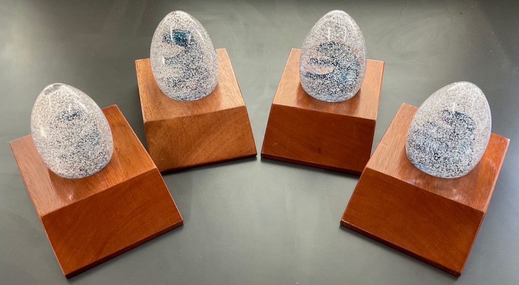 Four glass awards on wooden bases from the 2022 UK Geothermal Symposium