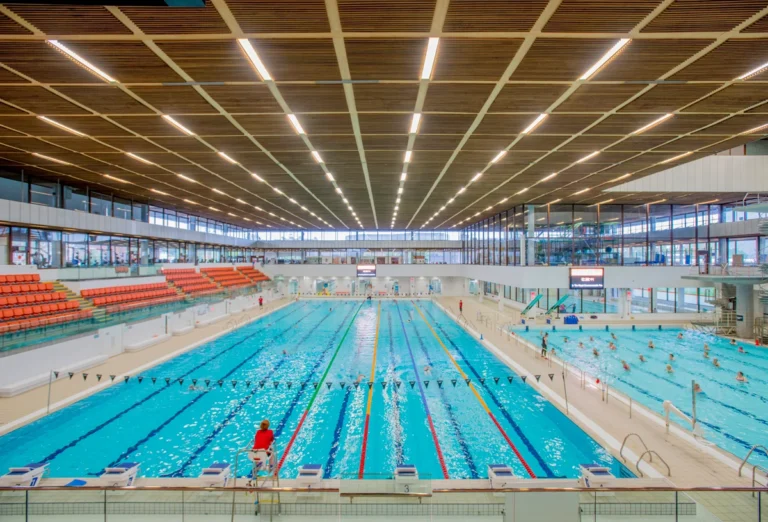 Indoor swimming pool and spectator seating at a modern council leisure centre